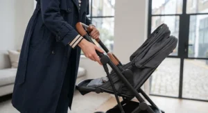 Demonstrating the quick one-handed fold mechanism of the best city pushchair.