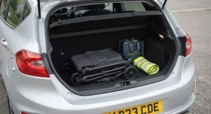 The lightest pushchair under 6kg tucked neatly into the boot of a small hatchback car, showing its compact storage capability.