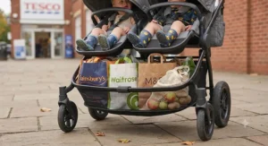 Spacious under-seat storage basket packed with shopping bags on a side by side double buggy