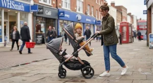 A sleek, modern best double pushchair being manoeuvred down a busy British town centre street.