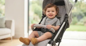 A happy toddler sitting comfortably in a high-quality best umbrella fold buggy
