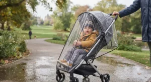A best umbrella fold buggy fitted with a rain cover during a typical British rainy day