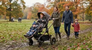 Sturdy all-terrain best tandem pushchair rolling across muddy park grass during an autumn family walk