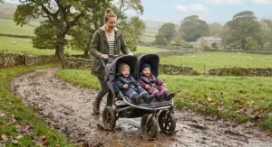 An all-terrain double pushchair tackling muddy British countryside paths with twins.