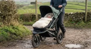 Sturdy all-terrain pushchair with a newborn insert navigating a rural British footpath