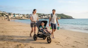 A family using a lightweight all-terrain pushchair on a sandy British beach