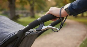 Close-up view of the safety handbrake and wrist strap on the lightweight jogging pushchair.