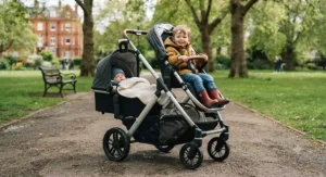 In-line tandem double pushchair carrying a newborn baby and an older toddler