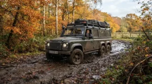 A rugged best toddler buggy being pushed along a muddy autumn trail in a country park