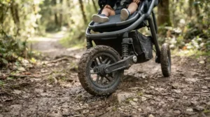 Suspension and robust wheels on a pushchair suitable from birth to 4 years on a muddy trail