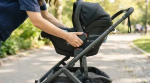 Demonstrating a click-and-go car seat attached to a pushchair with car seat under £300 chassis