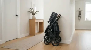 A space-saving travel stroller under £100 tucked away in a narrow hallway