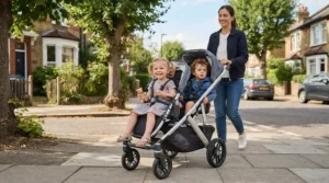 A tandem pushchair for twins under £600 showing two seats arranged in line on a suburban pavement.