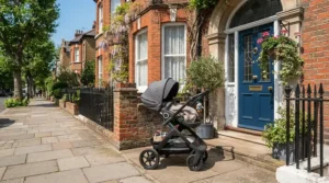 A versatile pushchair with reversible seat under £600 parked outside a traditional red brick terraced house.